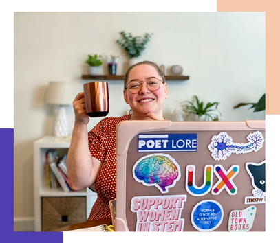 PictureCandice, a white woman, cheerfully raises her coffee cup up from behind a sticker covered laptop.